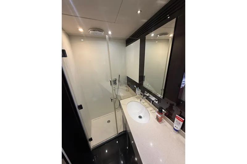 Slide: The Image of Luxurious bathroom in 2014 Sunseeker Predator 68 yacht with modern fixtures and glass shower. - 45
