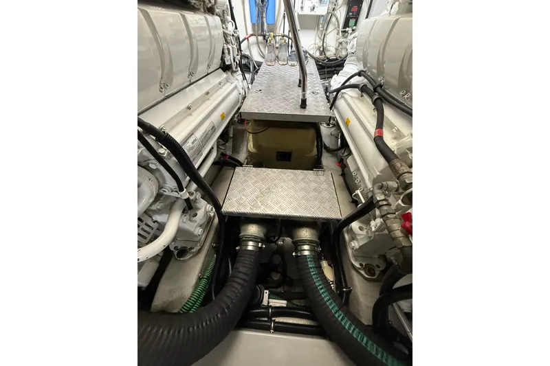 Slide: The Image of Engine room of 2014 Sunseeker Predator 68 yacht, showcasing mechanical components and piping. - 59