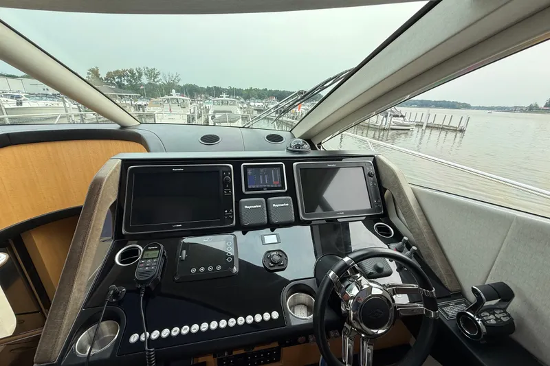 Slide: The Image of Cockpit of 2014 Sunseeker Predator 68 yacht with advanced navigation systems and steering wheel. - 50