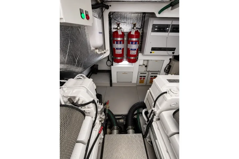 Slide: The Image of Engine room of 2014 Sunseeker Predator 68 yacht with fire extinguishers and control panels. - 57