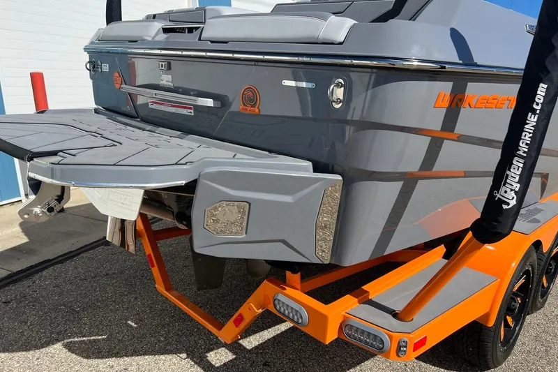 Slide: The Image of 2023 Malibu Wakesetter 22 LSV boat rear view with orange accents. - 9