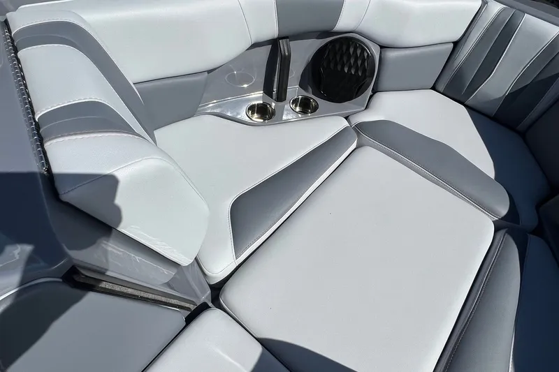 Slide: The Image of 2023 Malibu Wakesetter 22 LSV interior with gray and white seating, cup holders, and speaker. - 23