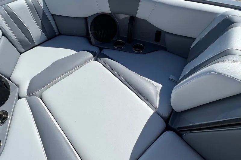 Slide: The Image of 2023 Malibu Wakesetter 22 LSV interior seating with cup holders and sleek design. - 22