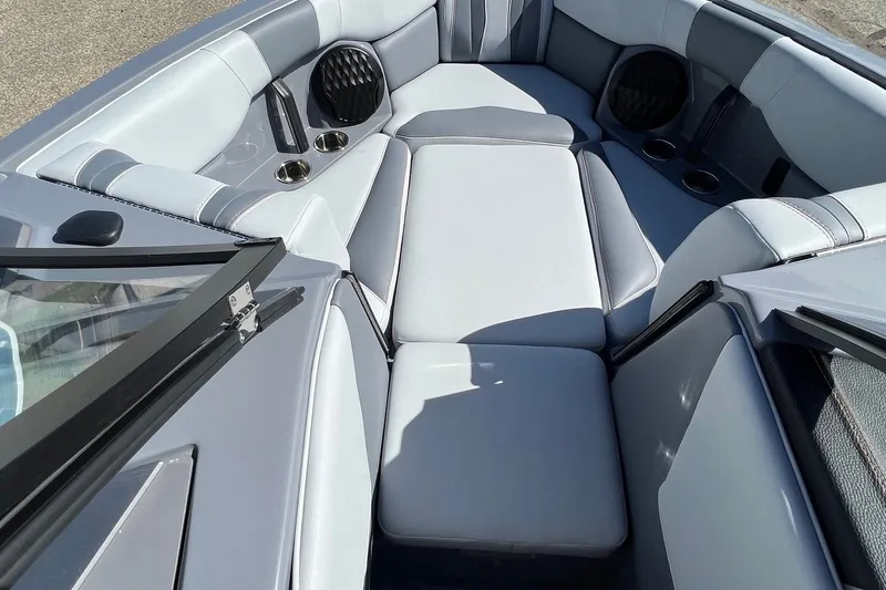 Slide: The Image of Interior of 2023 Malibu Wakesetter 22 LSV boat with gray seating and cup holders. - 21