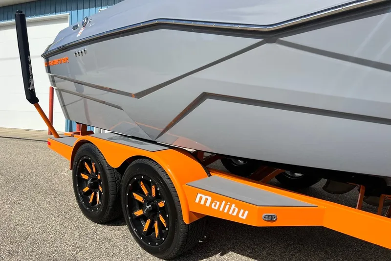 Slide: The Image of 2023 Malibu Wakesetter 22 LSV on orange trailer, showcasing sleek design and branding. - 8
