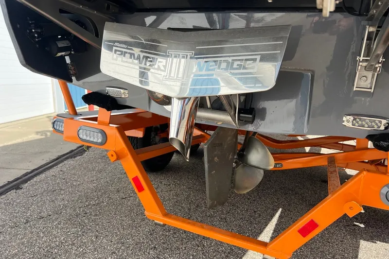 Slide: The Image of 2023 Malibu Wakesetter 22 LSV boat with Power Wedge III and orange trailer. - 11