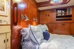 Slide: The Image of 1987 Camper & Nicholsons cruising sailboat cabin with cozy bed and wooden interior. - 30