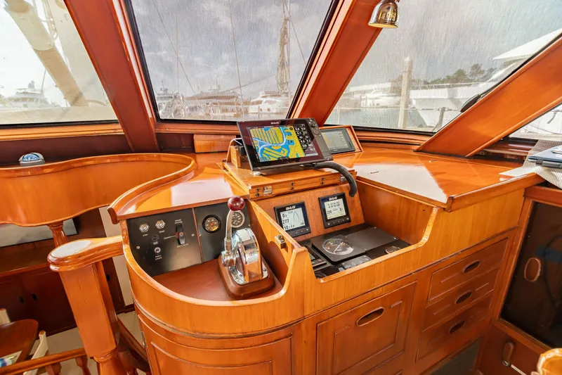 Slide: The Image of 1987 Camper & Nicholsons cruising sailboat helm with navigation equipment and wooden finish. - 15