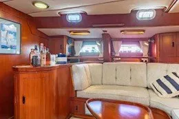 Slide: The Image of Luxurious 1987 Camper & Nicholsons cruising sailboat interior with elegant wood finish and cozy seating. - 22