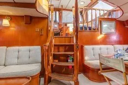 Slide: The Image of Interior of 1987 Camper & Nicholsons cruising sailboat with wooden stairs and cozy seating. - 19