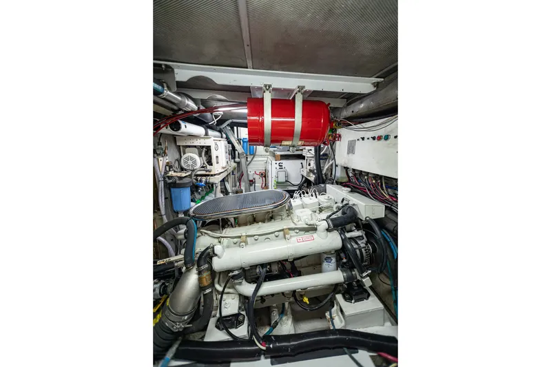 Slide: The Image of Engine room of a 1987 Camper & Nicholsons cruising sailboat, showcasing mechanical components. - 33