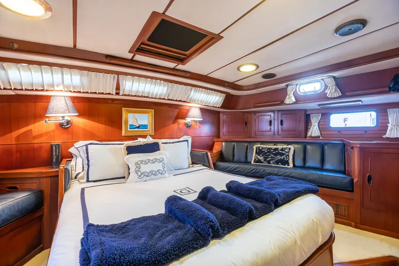 Slide: The Image of Luxurious 1987 Camper & Nicholsons sailboat cabin with elegant wood paneling and cozy bedding. - 28