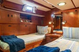 Slide: The Image of Interior of 1987 Camper & Nicholsons cruising sailboat with cozy twin beds and wooden cabinetry. - 31