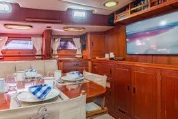 Slide: The Image of Interior of 1987 Camper & Nicholsons cruising sailboat with dining area and wooden cabinetry. - 24