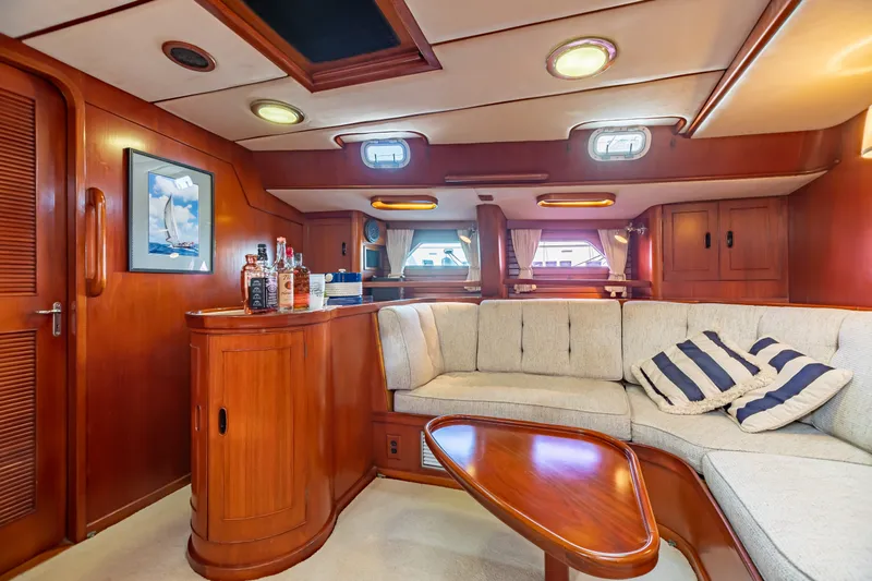 Slide: The Image of Luxurious 1987 Camper & Nicholsons cruising sailboat interior with elegant wood finish and cozy seating. - 21