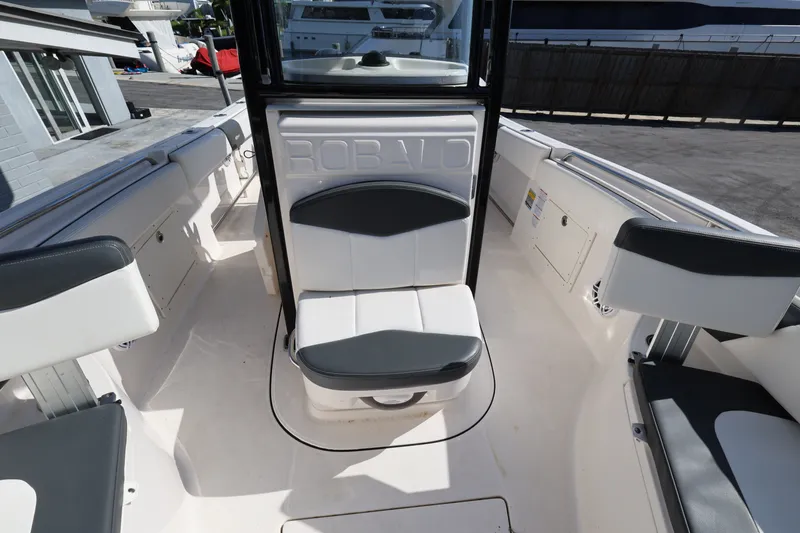 Slide: The Image of 2023 Robalo R242 Explorer boat interior with seating and storage compartments. - 17