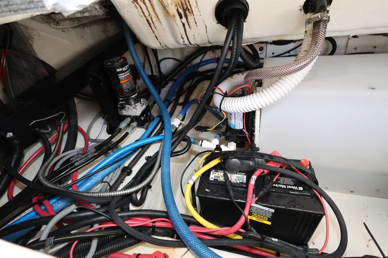 Slide: The Image of 2023 Robalo R242 Explorer boat wiring and battery compartment. - 23