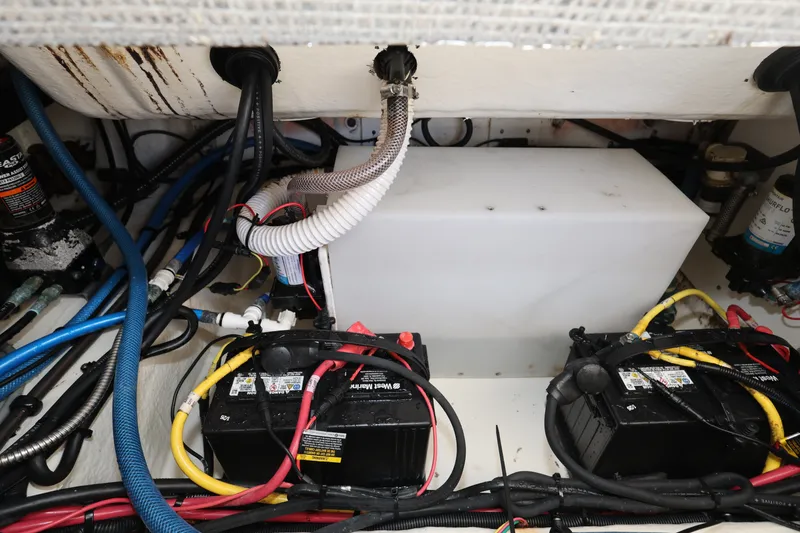 Slide: The Image of 2023 Robalo R242 Explorer engine compartment with batteries and wiring. - 21