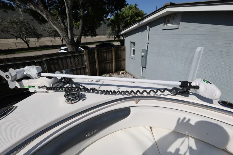 Slide: The Image of 2023 Robalo R242 Explorer boat with mounted trolling motor on deck. - 16