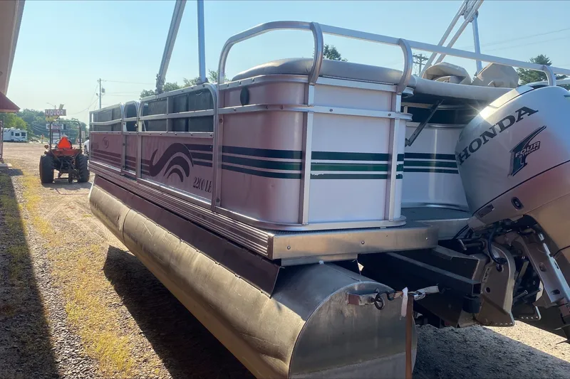 Slide: The Image of 2007 TMC 2200LE pontoon boat with Honda engine, parked near a tractor. - 5