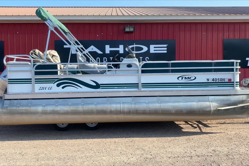 Slide: The Image of 2007 TMC 2200LE pontoon boat parked outside a red building. - 10