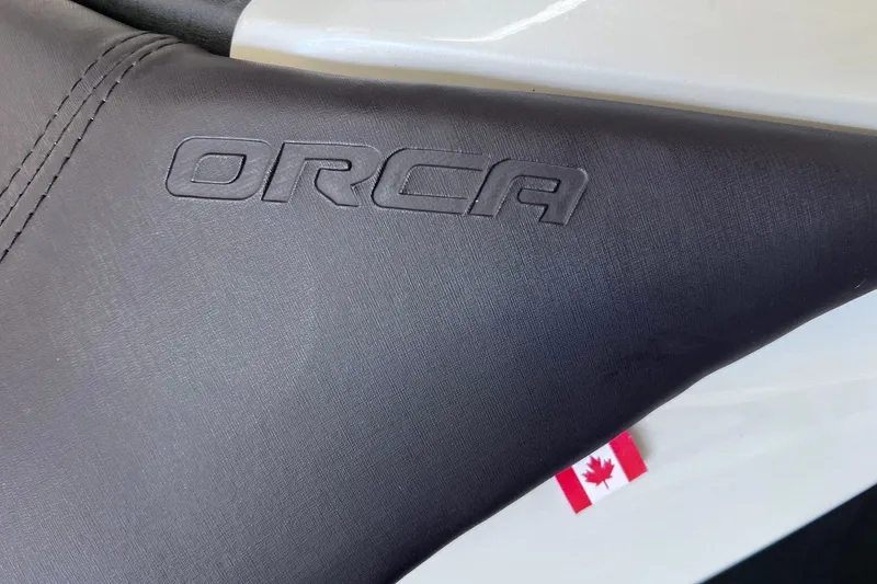 Slide: The Image of 2024 Taiga Orca seat detail with embossed logo and Canadian flag tag. - 13