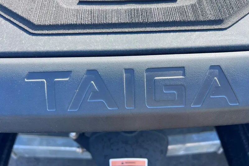Slide: The Image of 2024 Taiga Orca logo embossed on a vehicle surface. - 14