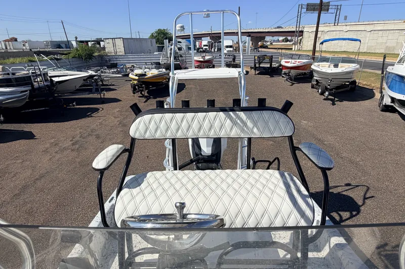 Slide: The Image of 2016 Dargel 250 HDX boat with white seating, parked among other boats. - 13