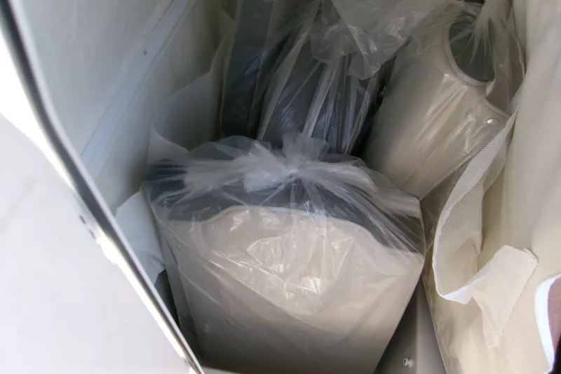 Slide: The Image of Storage compartment with wrapped items on a 2027 Key West 219 FS boat. - 15
