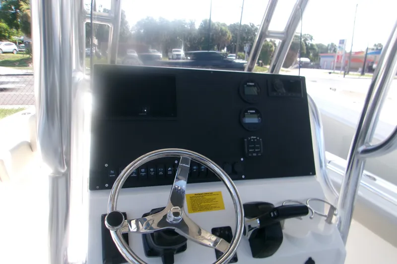 Slide: The Image of 2027 Key West 219 FS boat dashboard with steering wheel and control panel. - 6