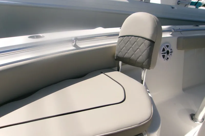 Slide: The Image of 2027 Key West 219 FS boat seat with quilted backrest and cup holder. - 16