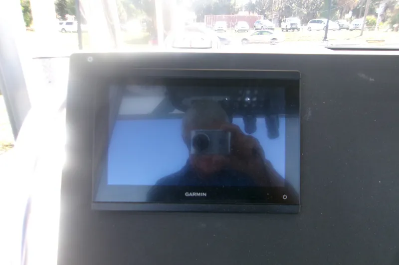 Slide: The Image of Garmin display on 2027 Key West 219 FS boat dashboard, reflecting surroundings. - 8