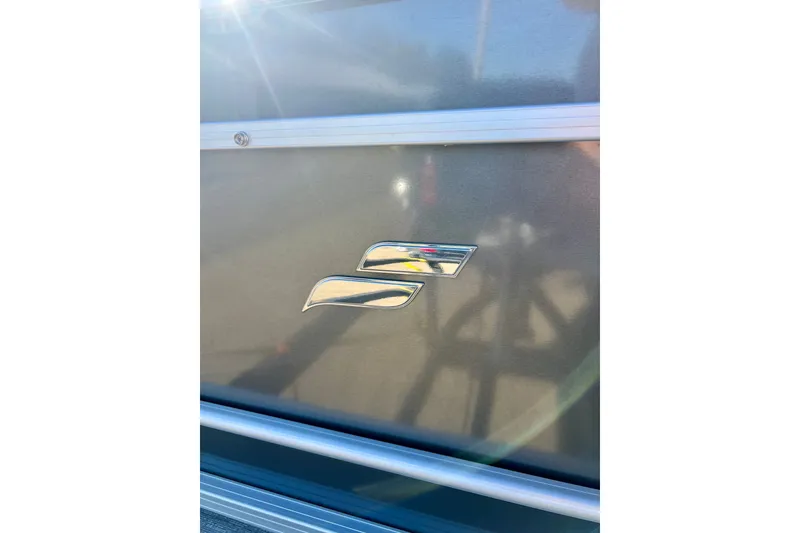 Slide: The Image of 2021 Starcraft EX 20 C logo on metallic surface, reflecting sunlight. - 36