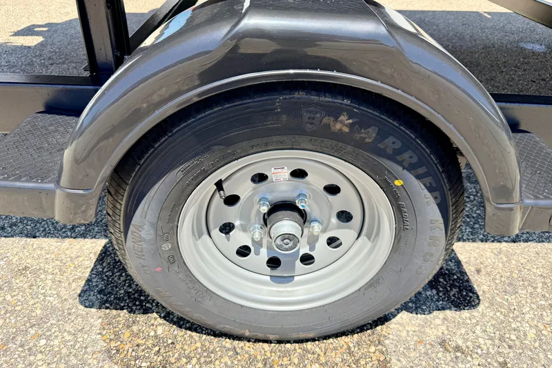Slide: The Image of Close-up of a 2021 Starcraft EX 20 C trailer wheel on asphalt. - 17