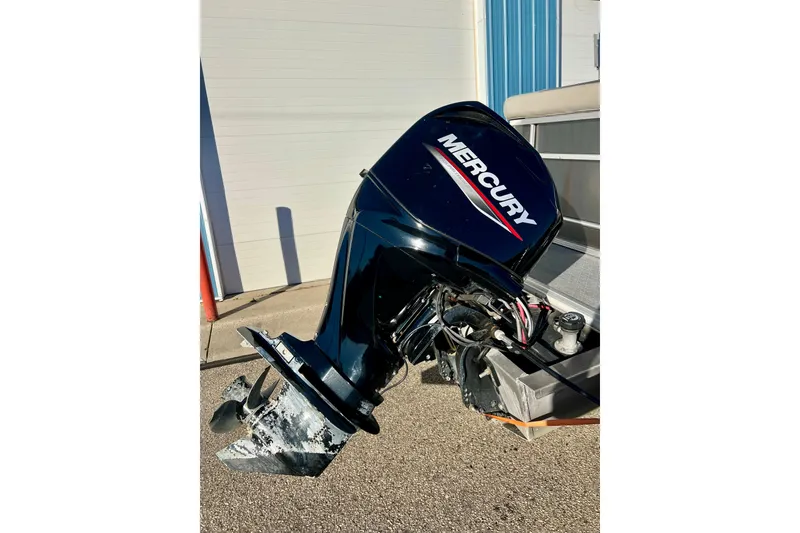 Slide: The Image of Mercury outboard motor on 2021 Starcraft EX 20 C boat, parked outdoors. - 29