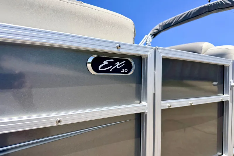 Slide: The Image of 2021 Starcraft EX 20 C pontoon boat exterior detail under clear blue sky. - 13