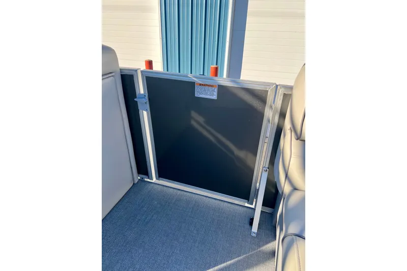 Slide: The Image of Interior view of a 2021 Starcraft EX 20 C boat, featuring a safety gate. - 74