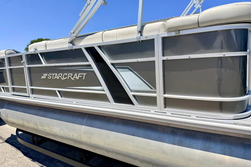 Slide: The Image of 2021 Starcraft EX 20 C pontoon boat with sleek gray exterior design. - 12