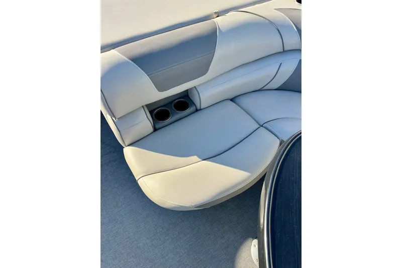 Slide: The Image of 2021 Starcraft EX 20 C boat interior with plush seating and cup holders. - 66