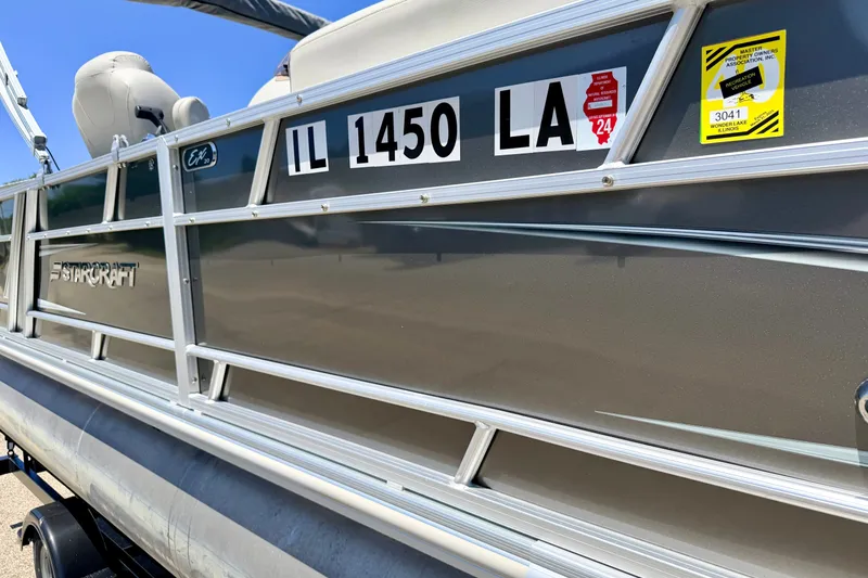 Slide: The Image of 2021 Starcraft EX 20 C pontoon boat with registration stickers, side view. - 8