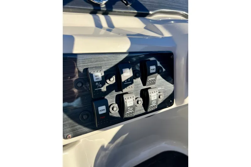 Slide: The Image of Control panel of 2021 Starcraft EX 20 C boat with labeled switches. - 54