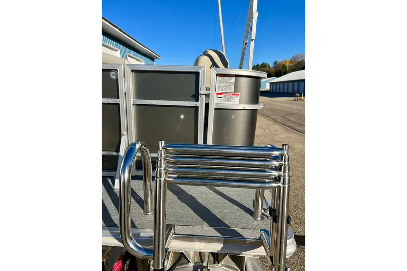 Slide: The Image of 2021 Starcraft EX 20 C boat with stainless steel ladder and dockside view. - 28