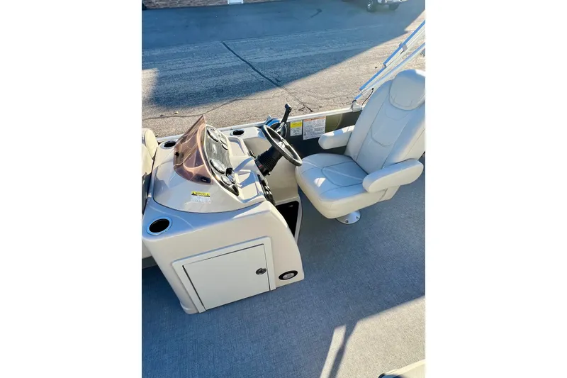 Slide: The Image of 2021 Starcraft EX 20 C boat interior with steering console and captain's chair. - 77
