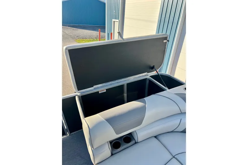 Slide: The Image of Open storage compartment on 2021 Starcraft EX 20 C boat with cushioned seating. - 69