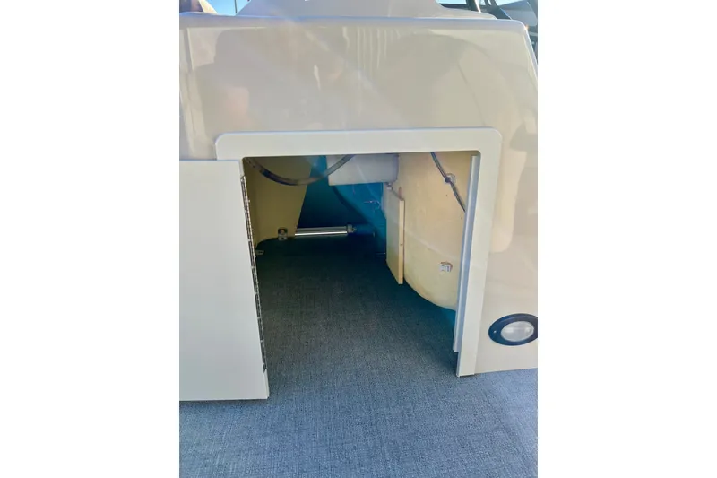 Slide: The Image of Storage compartment of a 2021 Starcraft EX 20 C boat, featuring carpeted flooring. - 49