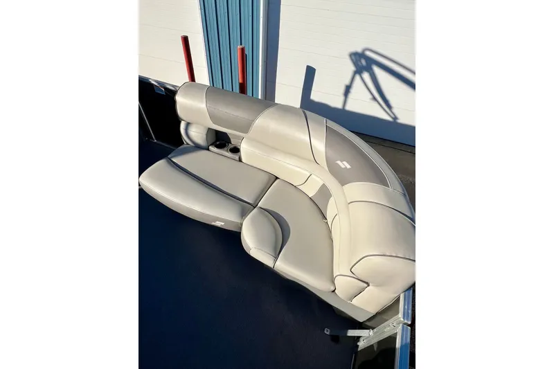 Slide: The Image of 2021 Starcraft EX 20 C boat seating with beige upholstery and cup holders. - 80