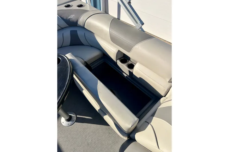 Slide: The Image of 2021 Starcraft EX 20 C boat interior with open storage compartment and cup holders. - 62
