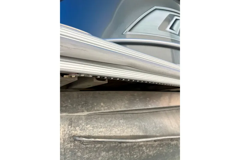 Slide: The Image of Close-up of 2021 Starcraft EX 20 C boat detail, showcasing sleek aluminum design. - 81