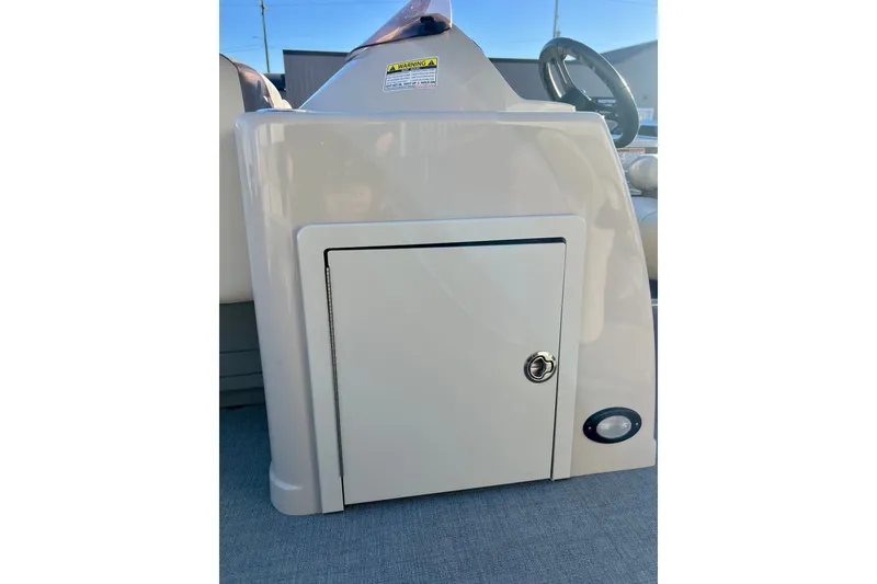 Slide: The Image of 2021 Starcraft EX 20 C boat console with storage compartment and steering wheel. - 48