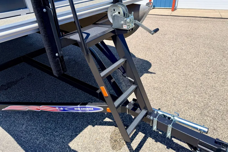 Slide: The Image of Trailer hitch and ladder of a 2021 Starcraft EX 20 C boat on pavement. - 19